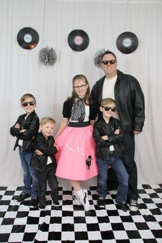 a group of people standing next to each other on a black and white checkered floor