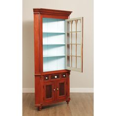 an old fashioned china cabinet with glass doors