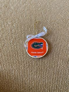 a florida gators pin sitting on top of a carpet