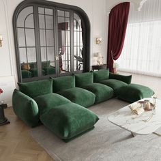 a living room filled with green couches next to a white table and large windows