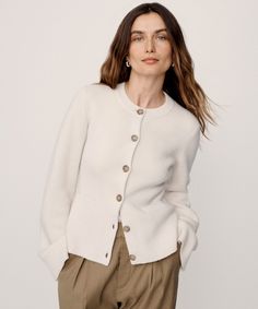 Cooper Cardigan Warm Ivory Featuring a structured silhouette that nips in at the waist and a very slight bell sleeve that instantly elevates any ensemble, this iconic cardigan effortlessly holds its own in any wardrobe. The fitted body enables versatile styling: wear it open like a blazer with a t-shirt underneath or buttoned up as a pullover. | 70% wool, 30% cashmere. Made in China of Peruvian yarn. Fitted button-down cardigan. Dry clean. Fits true to size. | Jenni Kayne Women's Cooper Cardigan