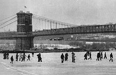 black and white photograph of people walking in front of the brooklyn bridge, new york city