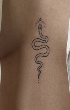 a woman's stomach with a snake tattoo on it