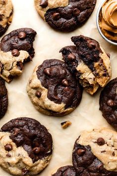 chocolate chip cookies and peanut butter spread on parchment paper