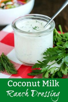 coconut milk ranch dressing in a glass jar with fresh herbs around it and on a red checkered tablecloth