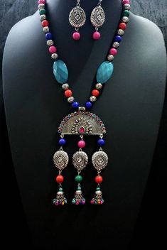 Dramatic, colorful oxidized silver Indian peacock necklace, with bead jhumka. The large central medallion is in the shape of an open peacock tail with a sparkly crystal border. Variety of bead shapes and sizes add visual interest. Perfect for tropical beach vacation as it is fun, lightweight and goes with all colors in your wardrobe. This is a very attractive necklace! You are certain to get many compliments! Necklace is 9.5 cm. Lobster claw clasp. Pendant measures 5 in x 3 in. including the dan Multicolor Peacock Design Temple Jewelry Sets, Traditional Multicolor Peacock Design Jewelry, Festive Multicolor Peacock Design Jewelry, Multicolor Peacock Temple Jewelry, Multicolor Peacock Design Temple Jewelry, Multicolor Peacock Design Temple Jewelry Necklace, Festive Multicolor Peacock Jewelry Sets, Festive Multicolor Peacock Design Jewelry Sets, Traditional Dangle Necklaces With Colorful Beads