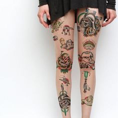 a woman's legs with tattoos on them