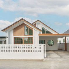 a house with a white fence in front of it