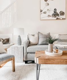 a living room filled with white furniture and large window covered in sunlight streaming through the windows