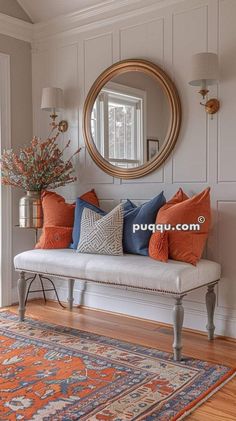 a white bench sitting in front of a mirror on top of a wooden floor next to a rug