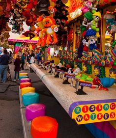 many colorful objects are on display at the fairground for people to see and take pictures