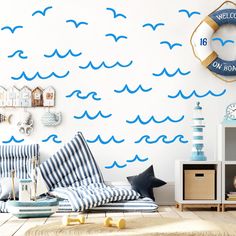 a living room with blue waves painted on the wall and a clock mounted to the wall