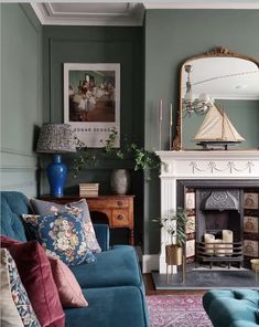 a living room filled with furniture and a fire place in front of a painting on the wall