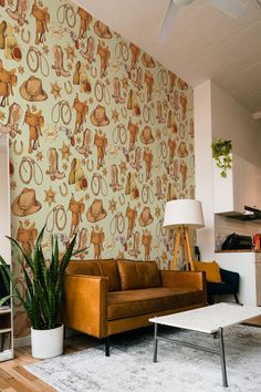 a living room filled with furniture and a wallpaper covered in cartoonish animal designs