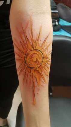 the sun is painted on the arm with watercolors