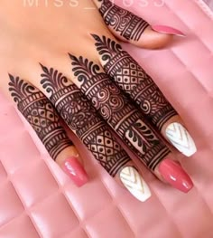 a woman's hand with henna tattoos on it