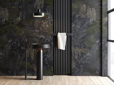 a black and white bathroom with palm leaves on the wall next to a radiator