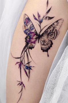 a woman's thigh with a butterfly and flowers on it