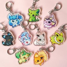 a bunch of keychains with different types of pokemon characters on them sitting in a circle