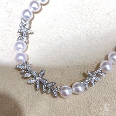 Highlight: Rare Japanese Akoya Rin Color Level Product Information Origin Japan MaterialAkoya Pearl, 18k Gold, and Diamond DimensionsNecklace Length 40-45 cm Adjustable Pearl Shaped: Round Size: 5.5-6 mm Quality: AAA Nacre: Very Thick Color: Rose Overtone Luster: Aurora Accessories Metal: 4.2 g of 18k White Gold Other: 0.46 ct of SI Quality Natural Diamond Luxury Akoya Pearl Diamond Necklace For Wedding, Diamond Pearl Necklace For Wedding, Wedding Pearl Necklace With Brilliant Cut Diamonds, Wedding Diamond Single Strand Pearl Necklace, Wedding Diamond Pearl Necklace Single Strand, White Bridal Necklace With Prong Setting, Wedding Single Strand Diamond Pearl Necklace, Elegant White Round Cut Bridal Necklace, Akoya Pearl Diamond Necklace For Wedding