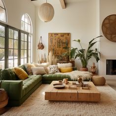 a living room filled with lots of furniture and plants on top of a white rug