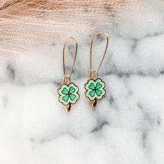 Keep luck close this St Patrick's day with a pair of green four leaf clover earrings. Featuring two green colors and kidney hoop style earring attachment.  Materials: 16k gold plated brass, enamel. Packaged in organza gift bags for easy gift giving. St Patricks Day Jewelry, 4 Leaf Clover, 4 Leaves, Clover Earrings, Four Leaf, Organza Gift Bags, Leaf Clover, St Patrick’s Day, Four Leaf Clover