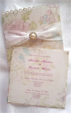 the wedding card has a pearl brooch on it