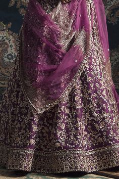 Purple lehenga with all-over floral embroidery. Paired with V-neck blouse, belt and two dupattas.
Component: 5
Embroidered
Neckline: V-Neck
Sleeve Length: Three Quarter
Fabric: Raw Silk
Color: Purple
Thread cut dana, dabka and sequin embroidery
Beaded tassels on the hem and sleeves of blouse
 - Aza Fashions Unstitched Lehenga With Intricate Embroidery For Festive Occasions, Festive Lehenga With Intricate Embroidery Unstitched, Festive Unstitched Lehenga With Intricate Embroidery, Unstitched Festive Lehenga With Resham Embroidery, Festive Dola Silk Lehenga With Intricate Embroidery, Festive Floor-length Embroidered Dupatta, Floor-length Embroidered Kundan Sets, Floor-length Dupatta With Intricate Embroidery For Festive Occasions, Embroidered Kundan Floor-length Sets