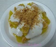 a white plate topped with fruit and yogurt