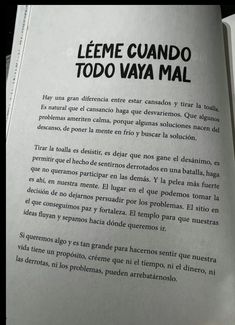 an open book with black and white writing on it's cover, in spanish