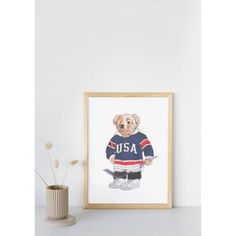 a painting of a bear in a hockey jersey on a shelf next to a vase with flowers