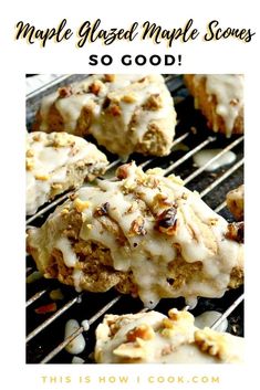 some cookies are sitting on a grill with white icing and pecans all over them