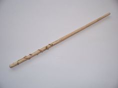 an old wooden stick is laying on the floor in front of a white background with no people around it