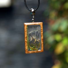 Dandelion Wish Pendant. Wood Resin Jewelry Handmade.  Gift for women ♥  You will be sent exactly the sample that you see in the photo and video  ♥♥ Please see the current discounts in the shop announcement: https://www.etsy.com/shop/TSMDecorations Handmade from natural wood and clear art resin.  Dandelion seeds are sealed in resin along with moss and green pebbles. Wooden frame made of the Australian BROWN MALLEE tree with a unique structure In addition to granting wishes, many people believe th Handmade Green Rectangular Necklace, Bohemian Green Jewelry With Pressed Flowers, Green Necklace With Natural Inclusions For Gift, Nature-inspired Green Jewelry With Pressed Flowers, Nature-inspired Green Flower Necklaces, Unique Green Necklace With Natural Inclusions, Nature-inspired Green Necklace With Pressed Flowers, Green Nature-inspired Necklace With Pressed Flowers, Green Nature-inspired Necklace