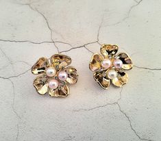 "Presenting a beautiful pair of CLIP ON earrings with mixed colour faux pearls and diamante in a gold tone cluster flower style, absolutely stunning addition to your outfit and with a beautiful sheen. Measuring approximately 3.2 cms in length and 3.2 cms in width. Please note the model is not full size.  Available in a stud version simply choose your preferred earring back from the drop down menu above. I do offer combined shipping on all my items, although this may mean a slight delay on delivery as some items are already made up and others will need to be created especially for you.  If you'd like to take advantage of the combined shipping option please pop all your items into your basket before completing check out. Most items will come out with a tag on - please be aware if the tag is Flower Shaped Clip-on Wedding Jewelry, Pink Flower Shaped Clip-on Earrings For Wedding, Pink Flower Clip-on Earrings For Wedding, Vintage Rose Gold Flower Earrings For Wedding, Statement Wedding Jewelry, Jewellery Bridal, Flower Style, Design Statement, Wedding Jewellery