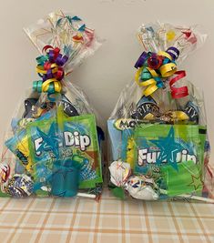 two bags filled with candy sitting on top of a table