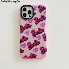 a pink phone case with hearts and the word barbie on it, sitting on a white surface