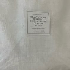 there is a label on the back of a white shirt that says, heavy weight textured belgian linen drapery