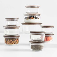 six glass containers with food in them stacked on top of each other