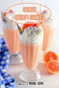 two glasses filled with orange cream shakes on top of a table