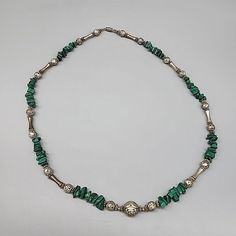 Add a touch of Southwestern elegance to your jewelry collection with this vintage statement necklace. Crafted from liquid sterling silver, this necklace features a beautiful malachite stone in a green color that will complement any outfit. The necklace is 26 inches long and has a barrel closure, making it easy to wear.  this necklace is a must-have for anyone who loves unique and eye-catching jewelry. The necklace is unisex and will suit both men and women. With its Native American brand, this necklace is a true piece of art that will add a touch of tribal style to your wardrobe. Shipped from a smoke-free home.  Please ask any questions in advance.  I combine shipping whenever possible to save you money.  Thank you for your interest! Turquoise Malachite Beaded Jewelry, Bohemian Malachite Jewelry With Polished Beads, Vintage Malachite Jewelry For Gifts, Vintage Malachite Jewelry Gift, Silver Malachite Necklace With Natural Stones, Silver Malachite Gemstone Necklace, Vintage Green Jewelry With Natural Stones, Green Malachite Bohemian Jewelry, Vintage Silver Turquoise Necklace With Natural Stones