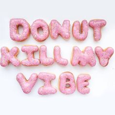 pink donuts with sprinkles are arranged in the shape of letters