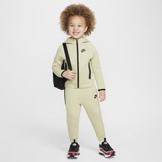 Made of bonded jersey knit fabric, this 2-piece set is inspired by the classic warmup suit. The hoodie has a full-zip closure that makes layering easy, and the matching tapered pants have ribbed cuffs and an elasticized waistband for a comfy fit the smallest athletes can play freely in. Nike Sportswear Tech Fleece, Kids Sportswear, Hoodie Set, Tech Fleece, Nike Kids, Tapered Pants, Jersey Knit Fabric, Comfy Fits, Nike Sportswear