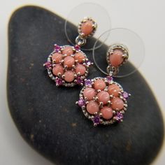 Oregon, Peach Opal, With Orissa Rhodolite Garnet. Earrings. Platinum Over Sterling Silver. Oregon, Peach Opal (1) Ct. (43) Mm. (7) Ct. (2.75) Mm. Orissa Rhodolite Garnet Rounds (1.75) Mm. Prong Set. Dangle. Peachy, Tones Salmon,Sorbet. Orissa, Rhodolite Garnet. Rosy Red Pink's. Hints Of Purplish Pink's. Great Combination Of Gemstones. Beautiful, Celestial. New. Gift Box Included. Elegant Orange Earrings With Natural Stones, Pink Multi-stone Round Earrings, Pink Multi-stone Earrings For Gift, Coral Gemstone Jewelry For Weddings, Formal Pink Round Flower Earrings, Formal Pink Flower Earrings, Pink Gemstone Accented Earrings For Gift, Elegant Coral Sterling Silver Jewelry, Pink Gemstone Accents Earrings For Gifts