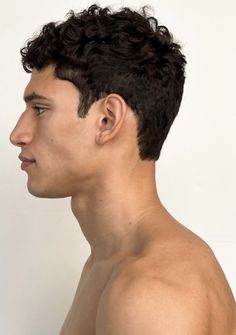 a shirtless man with no shirt on is looking off to the side and has his head tilted back