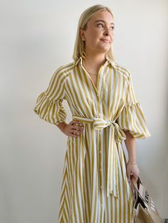 The Ischia Stripe Dress is a shirt dress with flair. Featuring a button down front, shirt collar, tie belt and drop shoulder to an oversized bubble sleeve and pockets. Pair with white tennis shoes or a pair of nude sandals to complete a perfect summer look. Fit: True to sizeFabric Content: 80% Rayon 20% NylonFabric Care: Machine Wash Cold Gentle Cycle, lay flat to dryMeasurements: 45" Shoulder to hemLining: NoZipper: No S:0-2 M:4-6 L:8-10 Summer Workwear Dresses With Balloon Sleeves, Spring Relaxed Fit Shirt Dress With Tie Waist, Spring Shirt Dress With Tie Waist And Relaxed Fit, Summer Shirt Dress For Spring Brunch, Spring Brunch Shirt Dress, Trendy Midi-length Spring Shirt Dress, Trendy Midi Shirt Dress For Spring, Summer Belted Shirt Dress In Relaxed Fit, Chic Spring Shirt Dress For Daywear