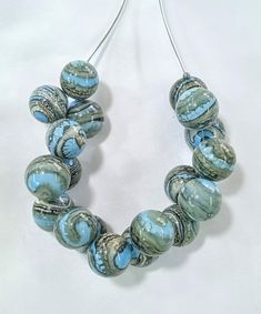 All products are handmade and unique. All beads are made by myself, in my own studio in Turkey-Selçuk-Şirince village. For my work i used Effetre (Moretti) - İtalian glass and the others. Shaped with breath.  Stainless steel wire, transparent silicone cord and nickel free clasp.  About 50 cm  long. If it falls on a hard surface, it may break. Do not wash with water. Wipe gently with a damp, soft cloth. The necklace is in an asymmetrical form.  The form does not deteriorate when you remove the br Party Large Beads Round Beaded Necklaces, Unique Necklaces With Round Beads For Party, Unique Round Bead Necklaces For Party, Turquoise Necklace With Large Beads For Party, Turquoise Round Beads Necklace For Party, Artsy Handmade Beaded Necklace For Gift, Handmade Artsy Beaded Necklaces For Gifts, Handmade Artsy Beaded Necklaces As Gift, Handmade Artsy Beaded Necklace Gift