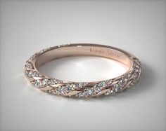 a rose gold wedding band with diamonds on it