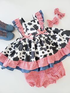 Sweet Girls Cow Dress This adorable dress features cow print, lightweight denim and red and white gingham. Double ruffles on flutter sleeves and hem. Ties in back with elastic for a perfect fit.  Perfect for a Cow Birthday party! Cow Print Dress Toddler, Farm Birthday Outfit For Mom, Farm Birthday Outfit, Farm Girl Outfits, Cow Print Dress, Cow Dress, Girl Ok, Cow Outfits, Farm Dress