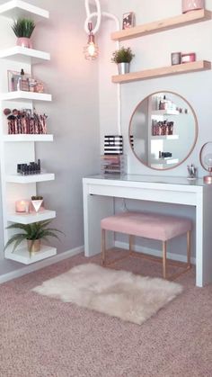 a white desk topped with a mirror and a pink stool